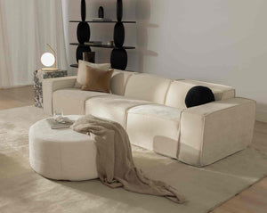 #color_inactive
Modular beige sofa from Rove Lab in a modern living room, featuring a marble side table with a spherical lamp, minimalistic shelving, and soft fabric decor on a round ottoman